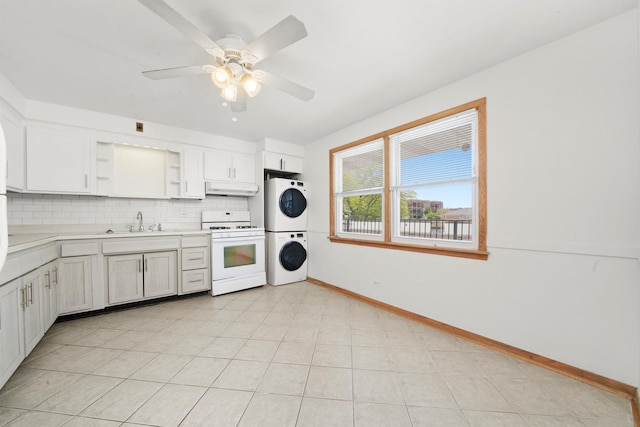 6534 N NW Hwy Unit 3D, Chicago, IL 60631 - kitchen with gas range gas stove, stacked washer / drying machine, under cabinet range hood, open shelves, and baseboards