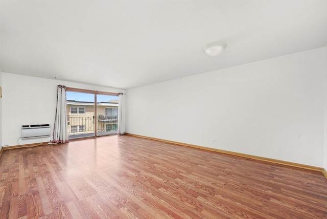6534 N NW Hwy Unit 3D, Chicago, IL 60631 - unfurnished living room with light wood finished floors, baseboards, and a wall mounted air conditioner