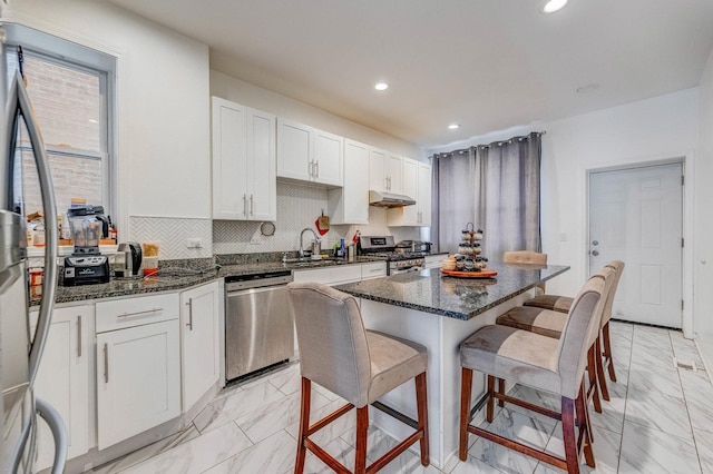 3340 W Polk St, Chicago, IL 60624 - kitchen with appliances with stainless steel finishes, light marble finish floors, a sink, a breakfast bar, and recessed lighting