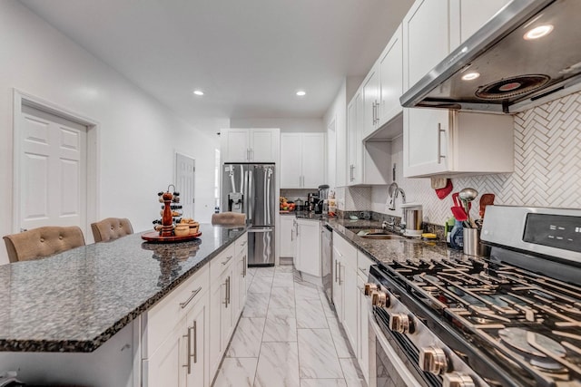 3340 W Polk St, Chicago, IL 60624 - kitchen with stainless steel appliances, range hood, a sink, light marble finish floors, and recessed lighting