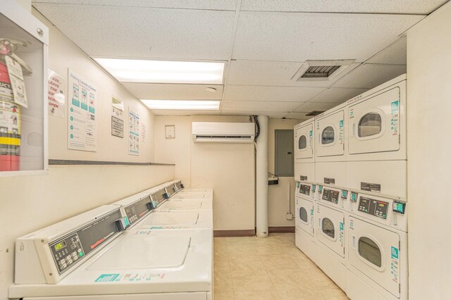 1221 N Dearborn St Unit 207N, Chicago, IL 60610 - community laundry featuring an AC wall unit, stacked washer / dryer, independent washer and dryer, and light tile patterned floors