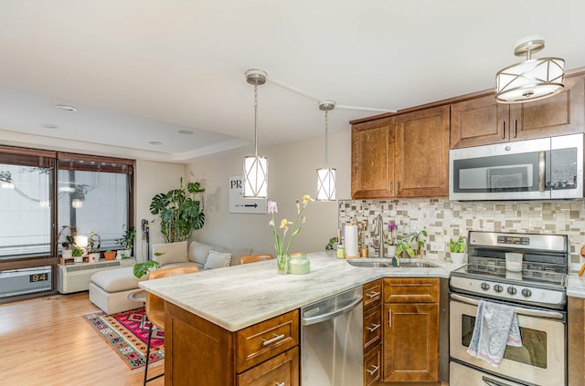 1221 N Dearborn St Unit 207N, Chicago, IL 60610 - kitchen with appliances with stainless steel finishes, a sink, brown cabinets, and decorative backsplash