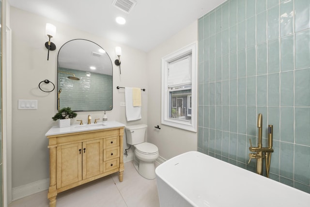 504 Newton Ave, Glen Ellyn, IL 60137 - bathroom featuring a freestanding tub, vanity, baseboards, tiled shower, and toilet