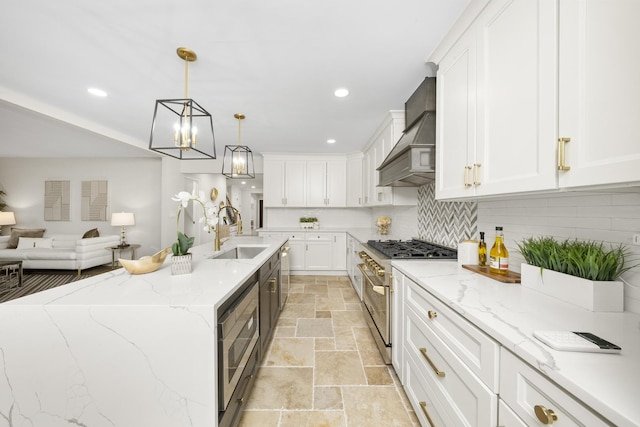 504 Newton Ave, Glen Ellyn, IL 60137 - kitchen featuring appliances with stainless steel finishes, a sink, stone tile floors, white cabinets, and premium range hood