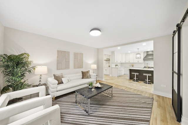 504 Newton Ave, Glen Ellyn, IL 60137 - living room with light wood-style flooring, baseboards, recessed lighting, and a barn door