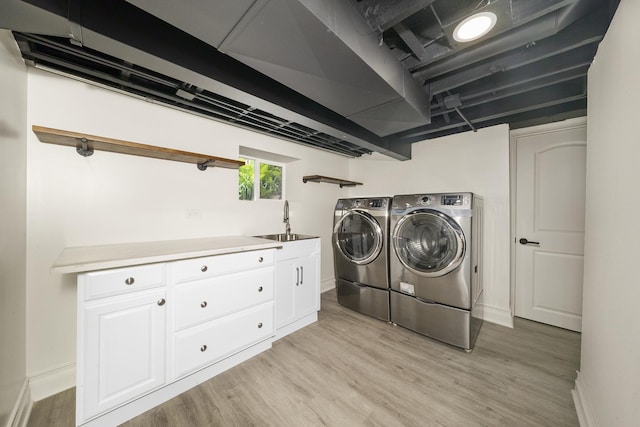 504 Newton Ave, Glen Ellyn, IL 60137 - laundry area featuring separate washer and dryer, light wood finished floors, baseboards, and cabinet space