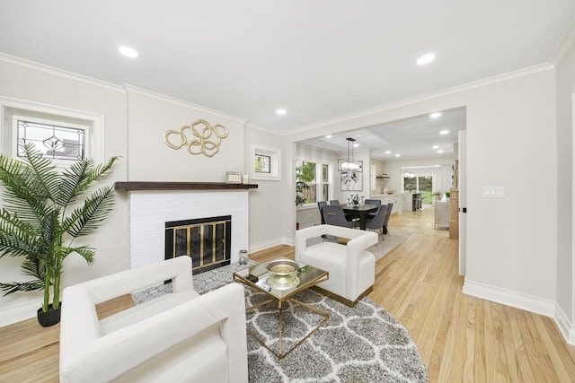 504 Newton Ave, Glen Ellyn, IL 60137 - living room with light wood-style flooring, baseboards, recessed lighting, a brick fireplace, and ornamental molding