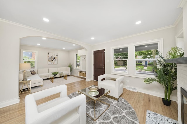 504 Newton Ave, Glen Ellyn, IL 60137 - living room with arched walkways, crown molding, baseboards, a glass covered fireplace, and wood finished floors