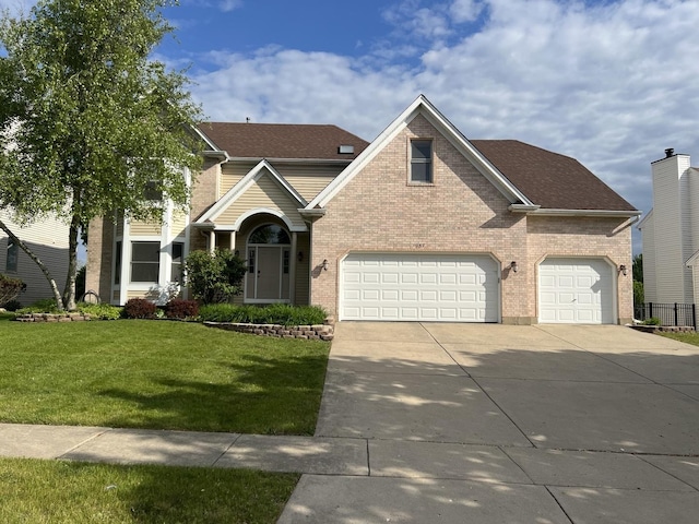 957 Chancery Ln, Cary, IL 60013 - traditional-style house featuring concrete driveway, a front yard, brick siding, a garage, and a shingled roof