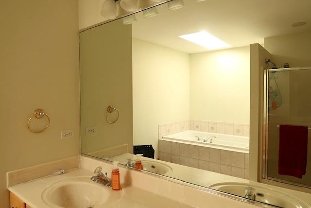 957 Chancery Ln, Cary, IL 60013 - full bathroom featuring double vanity, a garden tub, and a stall shower