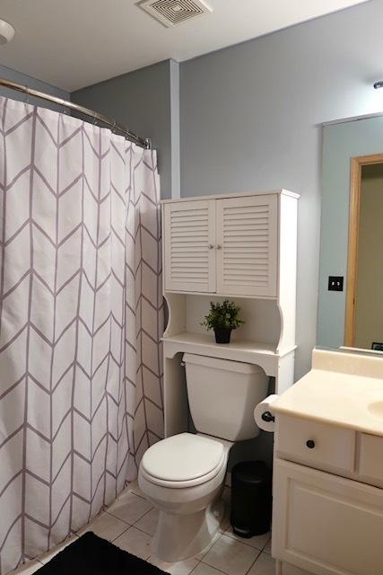 957 Chancery Ln, Cary, IL 60013 - bathroom featuring toilet, vanity, tile patterned floors, and a shower with shower curtain