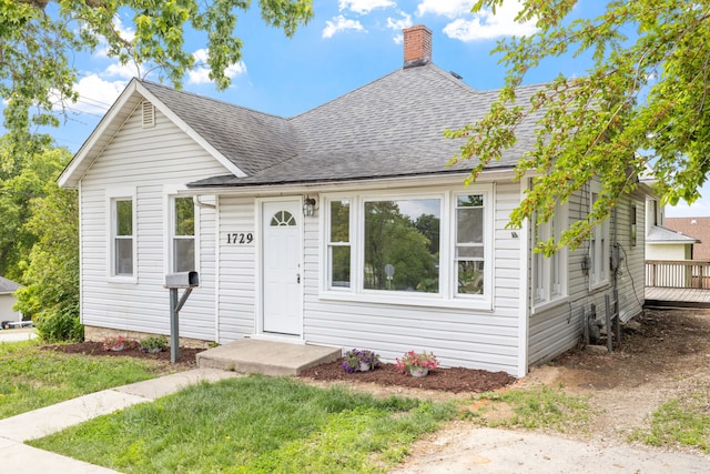 1729 S Hamilton St, Lockport, IL 60441 - view of front of home featuring roof with shingles, a chimney, and a front lawn
