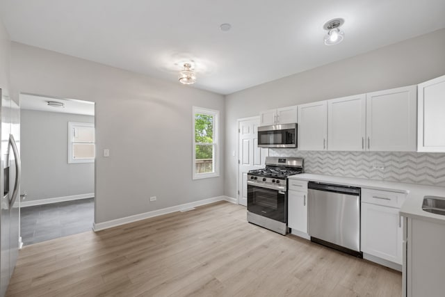 1729 S Hamilton St, Lockport, IL 60441 - kitchen featuring appliances with stainless steel finishes, tasteful backsplash, light countertops, and white cabinets