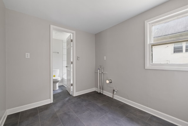 1729 S Hamilton St, Lockport, IL 60441 - spare room featuring dark tile patterned flooring and baseboards