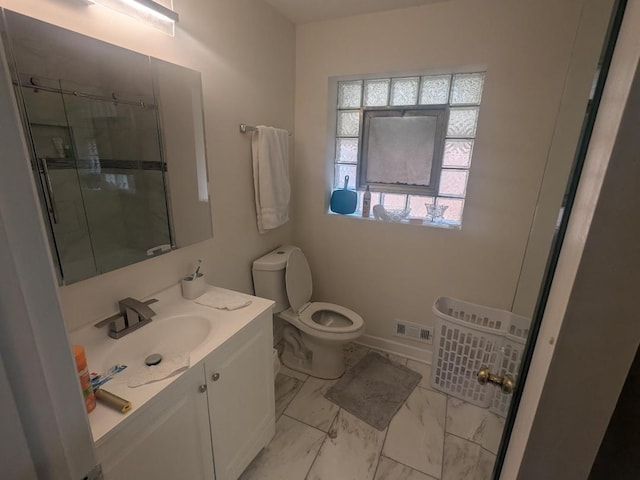 8918 S Euclid Ave, Chicago, IL 60617 - bathroom featuring vanity, marble look tiles, and a shower with door