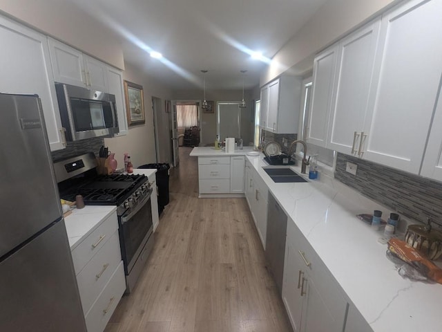 8918 S Euclid Ave, Chicago, IL 60617 - kitchen with appliances with stainless steel finishes, tasteful backsplash, white cabinets, and light stone countertops