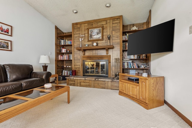 1720 Brookhill Ln, Sycamore, IL 60178 - living room featuring a fireplace, light colored carpet, a textured ceiling, and baseboards