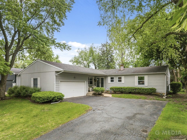 1720 Brookhill Ln, Sycamore, IL 60178 - ranch-style home featuring asphalt driveway, a garage, a front yard, and a chimney