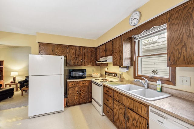1720 Brookhill Ln, Sycamore, IL 60178 - kitchen with white appliances, under cabinet range hood, a sink, light countertops, and light flooring