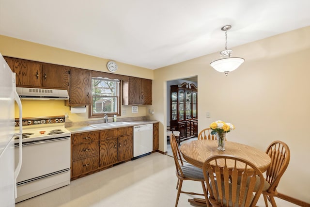 1720 Brookhill Ln, Sycamore, IL 60178 - kitchen with white appliances, range hood, a sink, light countertops, and decorative light fixtures