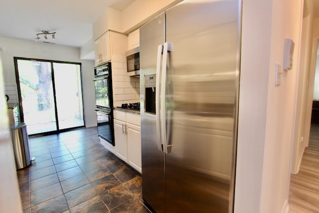 10 Old Oak Dr Unit 103, Buffalo Grove, IL 60089 - kitchen with black appliances, white cabinetry, and backsplash