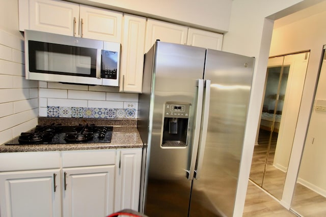 10 Old Oak Dr Unit 103, Buffalo Grove, IL 60089 - kitchen featuring appliances with stainless steel finishes, backsplash, white cabinets, and light wood-style floors