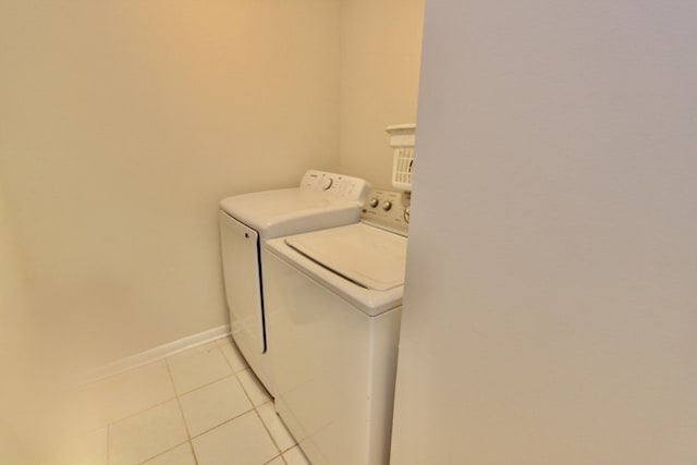 10 Old Oak Dr Unit 103, Buffalo Grove, IL 60089 - laundry room featuring washer and dryer, light tile patterned flooring, and baseboards