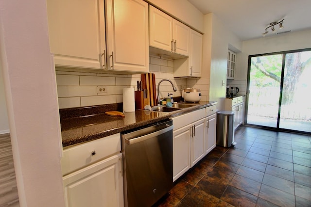 10 Old Oak Dr Unit 103, Buffalo Grove, IL 60089 - kitchen featuring stainless steel dishwasher, a sink, white cabinets, tasteful backsplash, and dark stone countertops