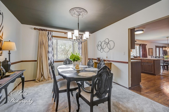 1402 Winaki Trl, Algonquin, IL 60102 - dining space featuring a chandelier, carpet, plenty of natural light, and baseboards