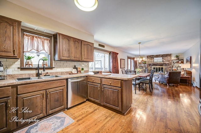 1402 Winaki Trl, Algonquin, IL 60102 - kitchen with stainless steel dishwasher, a sink, light wood finished floors, and light countertops