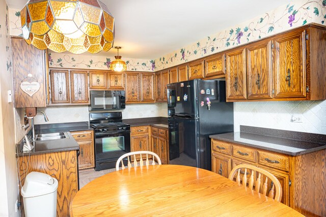 14207 Concord Dr, Orland Park, IL 60462 - kitchen featuring black appliances, a sink, brown cabinets, and dark countertops