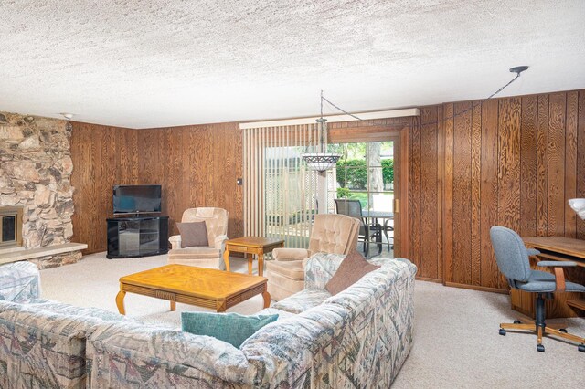 14207 Concord Dr, Orland Park, IL 60462 - living room featuring carpet flooring, a textured ceiling, wood walls, and a fireplace