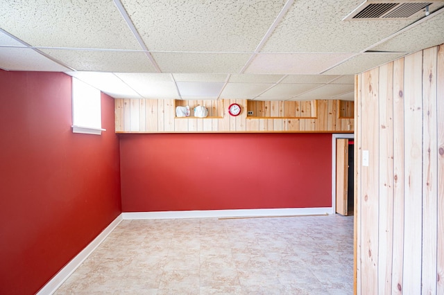 14207 Concord Dr, Orland Park, IL 60462 - below grade area featuring a paneled ceiling, wooden walls, baseboards, and tile patterned floors
