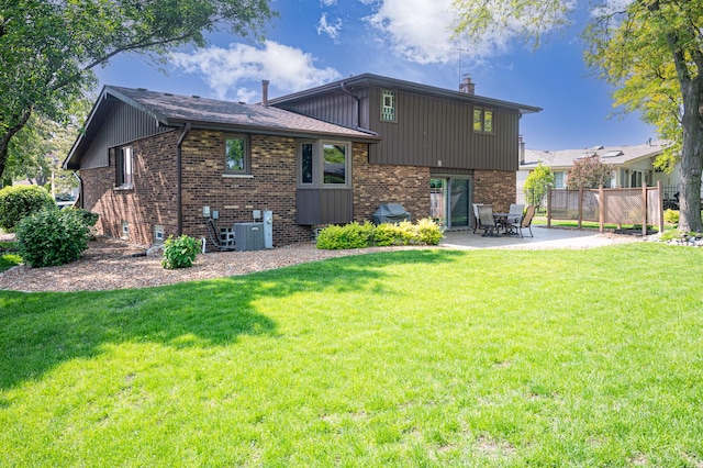 14207 Concord Dr, Orland Park, IL 60462 - back of property with a patio area, brick siding, a chimney, and cooling unit
