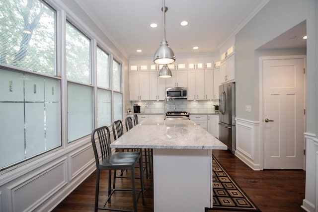 235 S Marion St Unit C, Oak Park, IL 60302 - kitchen with appliances with stainless steel finishes, tasteful backsplash, dark wood-style floors, white cabinetry, and ornamental molding