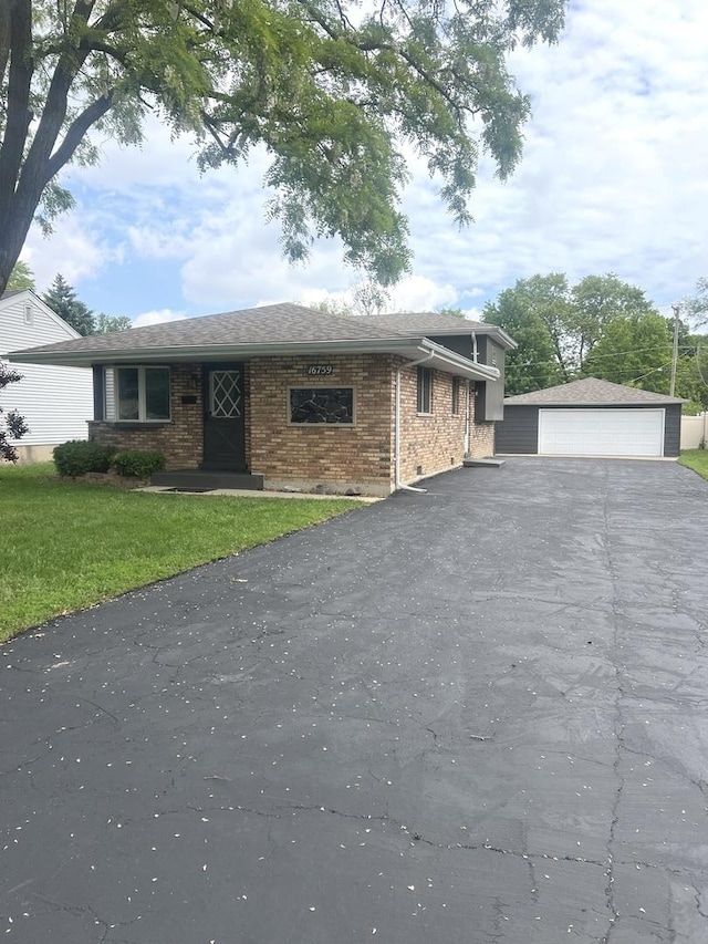 16759 Forest View Dr, Tinley Park, IL 60477 - tri-level home featuring brick siding, a garage, a front lawn, and an outdoor structure