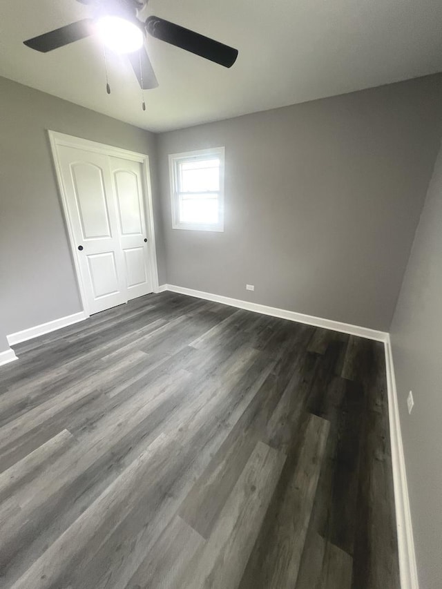 16759 Forest View Dr, Tinley Park, IL 60477 - unfurnished bedroom with baseboards, a closet, dark wood-style flooring, and ceiling fan