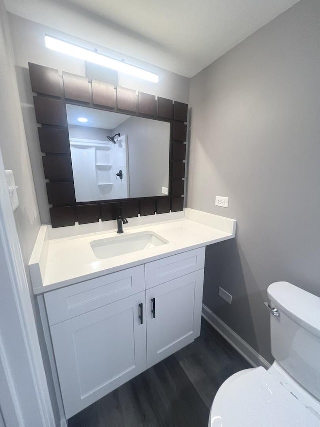 16759 Forest View Dr, Tinley Park, IL 60477 - bathroom with toilet, vanity, wood finished floors, a shower, and baseboards