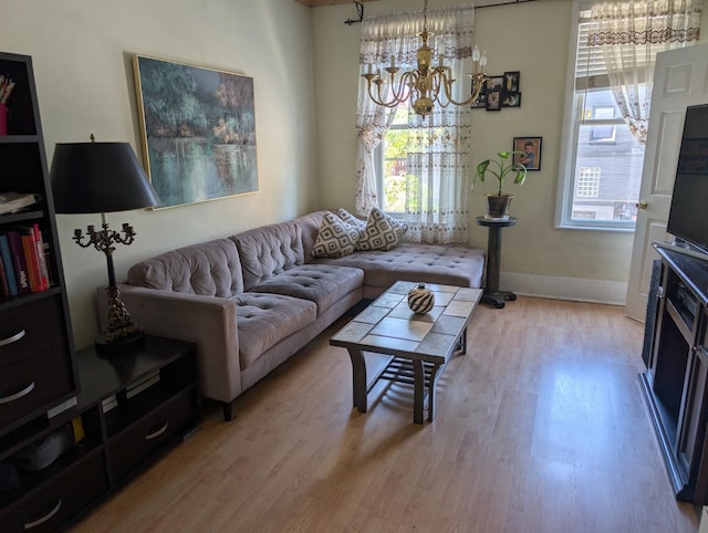 3233 S Morgan St, Chicago, IL 60608 - living area featuring light wood-style flooring, a chandelier, and baseboards