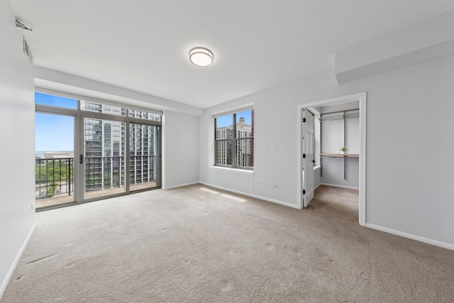 1250 S Indiana Ave Unit 1301, Chicago, IL 60605 - unfurnished bedroom with carpet floors, baseboards, and access to exterior