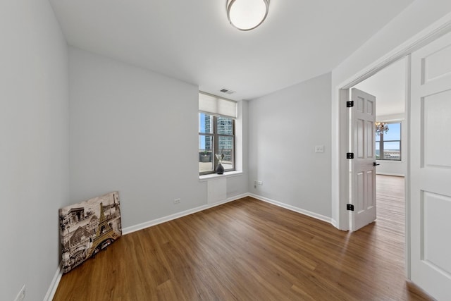 1250 S Indiana Ave Unit 1301, Chicago, IL 60605 - spare room featuring wood finished floors, plenty of natural light, and baseboards