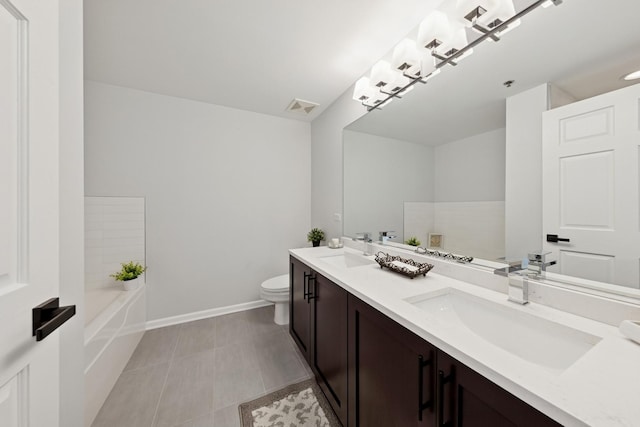 1250 S Indiana Ave Unit 1301, Chicago, IL 60605 - bathroom featuring double vanity, toilet, a tub to relax in, baseboards, and tile patterned flooring