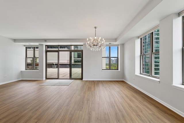 1250 S Indiana Ave Unit 1301, Chicago, IL 60605 - empty room with a chandelier, wood finished floors, and baseboards
