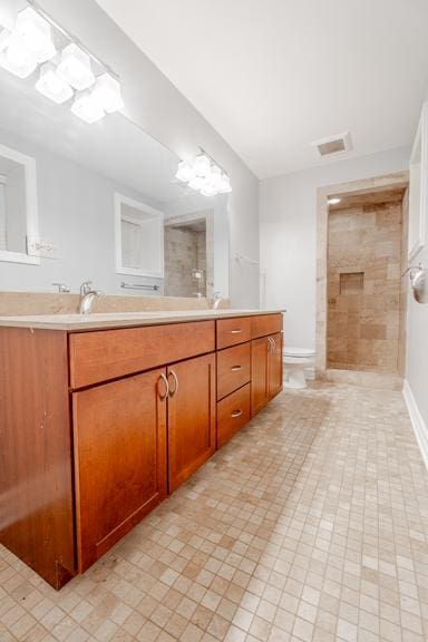 4111 N Kenmore Ave Unit 1Ng, Chicago, IL 60613 - bathroom featuring double vanity, tiled shower, toilet, and tile patterned floors
