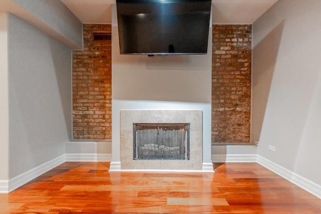 4111 N Kenmore Ave Unit 1Ng, Chicago, IL 60613 - unfurnished living room featuring wood finished floors, a fireplace, and baseboards