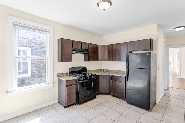 4130 W Potomac Ave, Chicago, IL 60651 - kitchen featuring black appliances, under cabinet range hood, dark brown cabinets, a sink, and baseboards