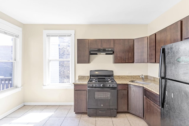 4130 W Potomac Ave, Chicago, IL 60651 - kitchen with black appliances, under cabinet range hood, a sink, and light tile patterned floors