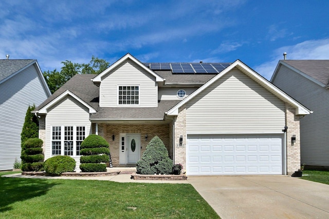 1422 Deer Creek Ln, Lake In The Hills, IL 60156 - traditional home with concrete driveway, brick siding, a front lawn, and solar panels