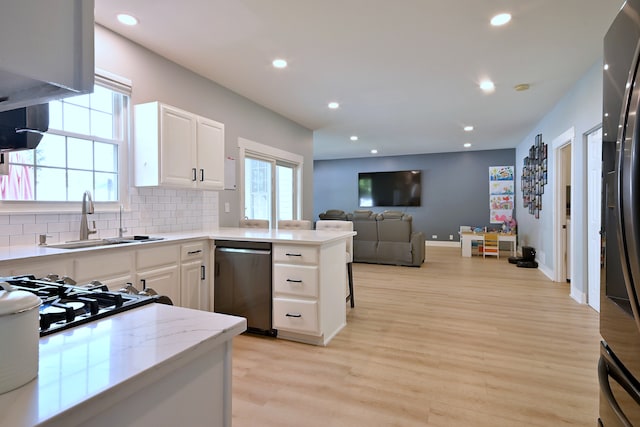1422 Deer Creek Ln, Lake In The Hills, IL 60156 - kitchen featuring appliances with stainless steel finishes, a sink, light wood-style floors, white cabinets, and recessed lighting