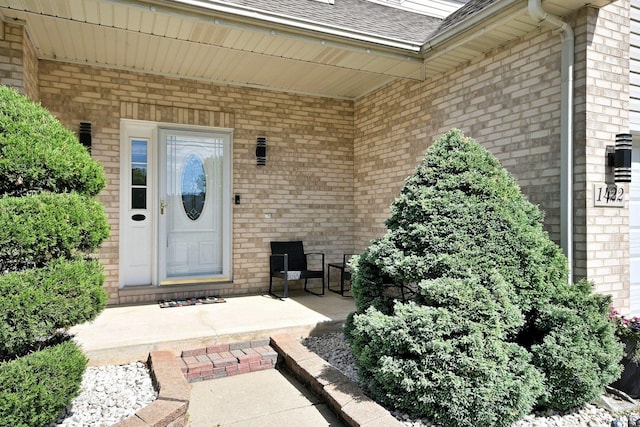 1422 Deer Creek Ln, Lake In The Hills, IL 60156 - view of exterior entry with brick siding, a shingled roof, and a porch